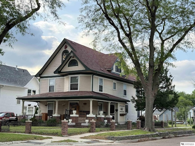 2850 P St, Lincoln, NE 68503 - victorian house with covered porch and a fenced front yard