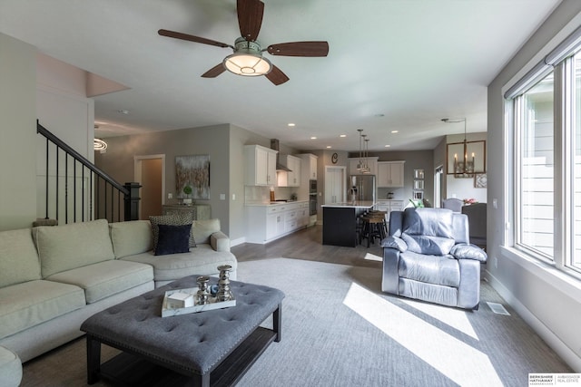 2203 N 188th Ave, Elkhorn, NE 68022 - living area with ceiling fan, baseboards, stairs, a chandelier, and dark wood finished floors