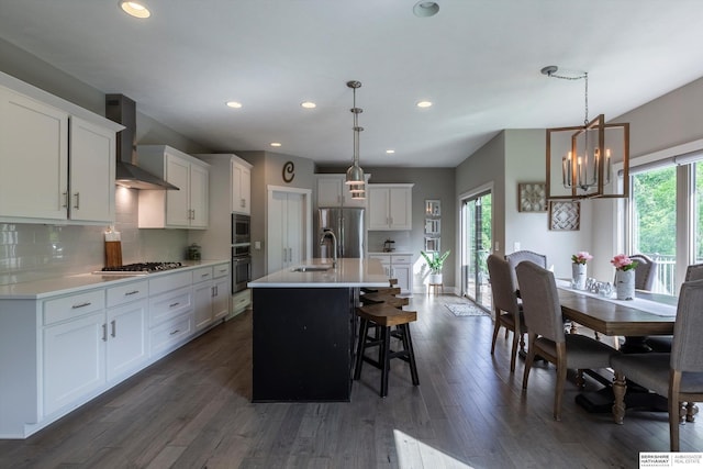 2203 N 188th Ave, Elkhorn, NE 68022 - kitchen with appliances with stainless steel finishes, wall chimney exhaust hood, a sink, dark wood-style floors, and light countertops