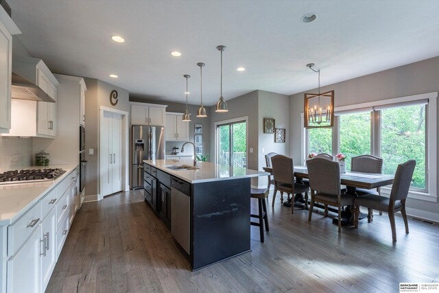 2203 N 188th Ave, Elkhorn, NE 68022 - kitchen with stainless steel appliances, a sink, recessed lighting, light countertops, and dark wood finished floors