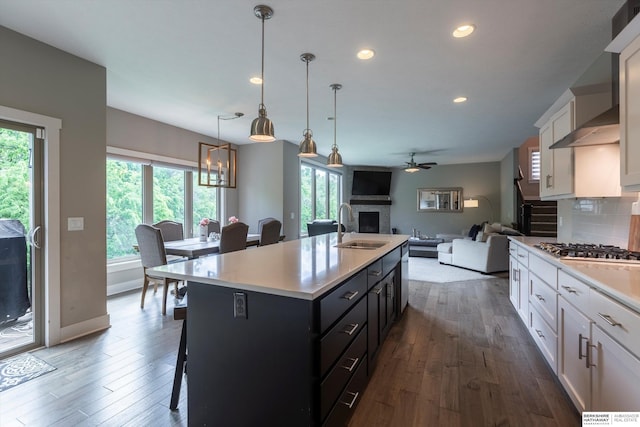 2203 N 188th Ave, Elkhorn, NE 68022 - kitchen with a sink, stainless steel gas cooktop, white cabinets, a ceiling fan, and light countertops