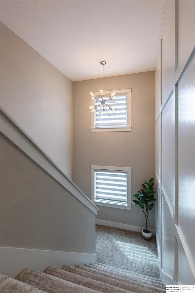 2203 N 188th Ave, Elkhorn, NE 68022 - stairway with a chandelier, baseboards, and carpet