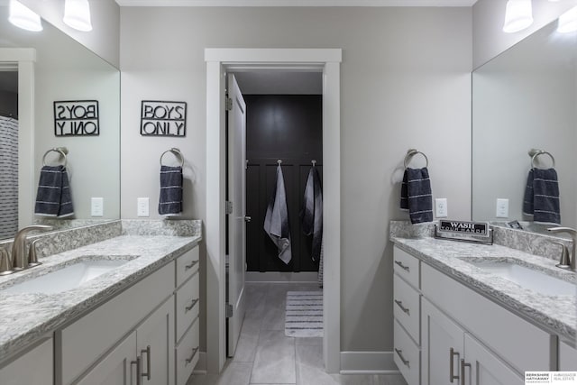 2203 N 188th Ave, Elkhorn, NE 68022 - bathroom featuring two vanities, baseboards, and marble look tile flooring