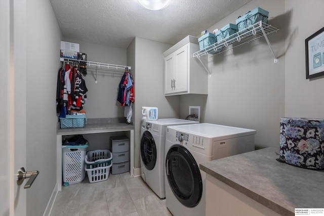 2203 N 188th Ave, Elkhorn, NE 68022 - washroom with cabinet space, washing machine and clothes dryer, a textured ceiling, and baseboards
