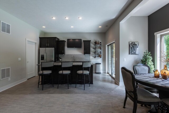 2203 N 188th Ave, Elkhorn, NE 68022 - kitchen with a center island, a sink, a kitchen breakfast bar, baseboards, and recessed lighting