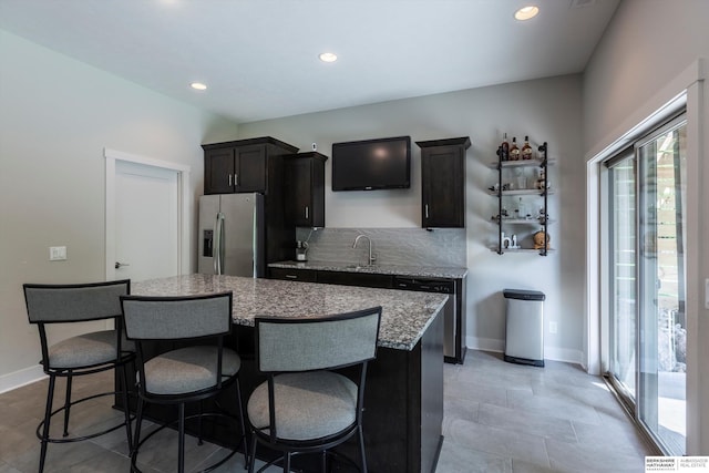 2203 N 188th Ave, Elkhorn, NE 68022 - kitchen featuring appliances with stainless steel finishes, a kitchen island, a kitchen bar, recessed lighting, and backsplash