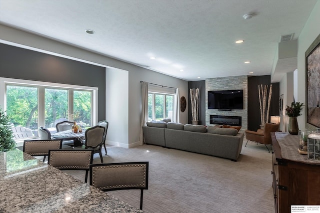 2203 N 188th Ave, Elkhorn, NE 68022 - living room with light colored carpet, a fireplace, baseboards, and recessed lighting