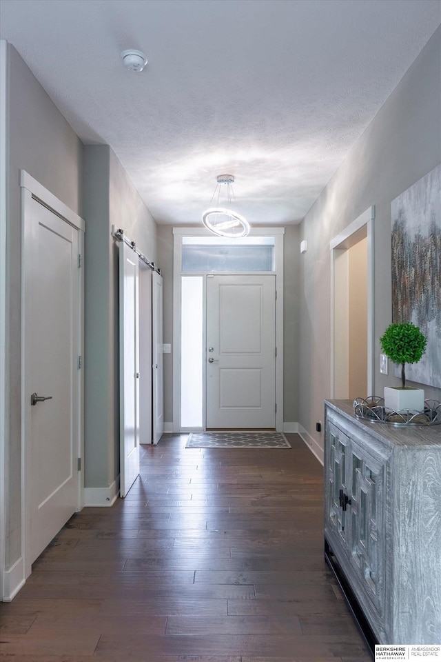 2203 N 188th Ave, Elkhorn, NE 68022 - entrance foyer with a barn door, dark wood-type flooring, baseboards, and a chandelier