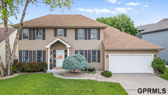 16404 Polk St, Omaha, NE 68135 - colonial-style house featuring a garage, concrete driveway, a front lawn, central air condition unit, and a shingled roof