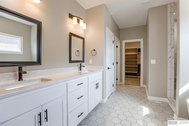 3938 S 207th St, Elkhorn, NE 68022 - full bathroom featuring double vanity, a tile shower, a spacious closet, baseboards, and tile patterned flooring