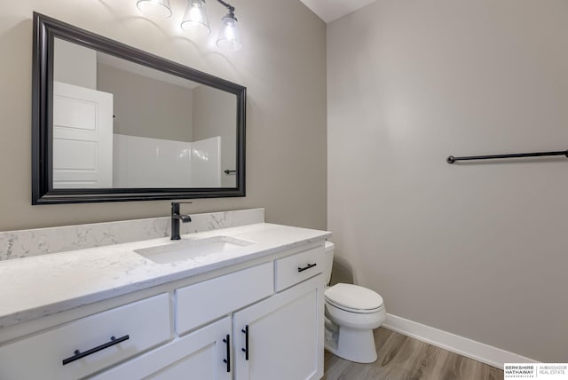 3938 S 207th St, Elkhorn, NE 68022 - bathroom with toilet, vanity, wood finished floors, baseboards, and a shower