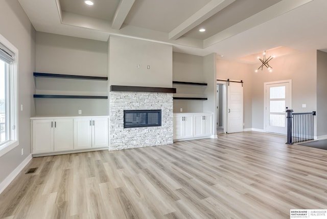 3938 S 207th St, Elkhorn, NE 68022 - unfurnished living room featuring a barn door, light wood-type flooring, beamed ceiling, baseboards, and a chandelier