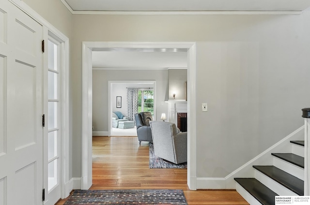 5119 Hamilton St, Omaha, NE 68132 - entrance foyer with wood finished floors, ornamental molding, baseboards, a fireplace, and stairs