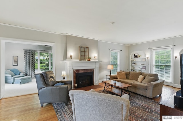 5119 Hamilton St, Omaha, NE 68132 - living room featuring wood finished floors, crown molding, and a brick fireplace