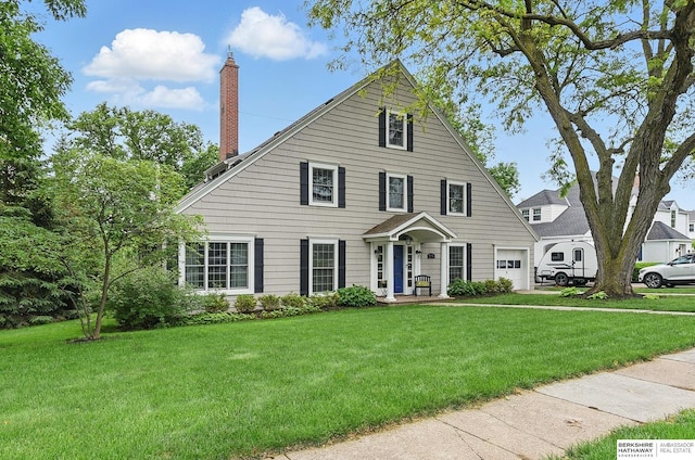5119 Hamilton St, Omaha, NE 68132 - view of front of property featuring a garage, a chimney, and a front yard