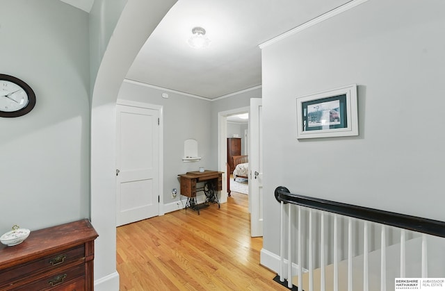 5119 Hamilton St, Omaha, NE 68132 - corridor with an upstairs landing, ornamental molding, light wood-type flooring, arched walkways, and baseboards