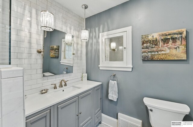 5119 Hamilton St, Omaha, NE 68132 - bathroom featuring toilet, vanity, and baseboards