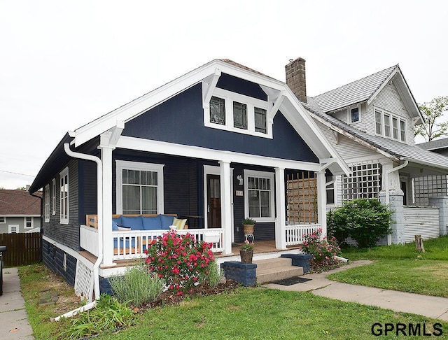 806 N 43rd St, Omaha, NE 68131 - bungalow-style home with a porch and a chimney