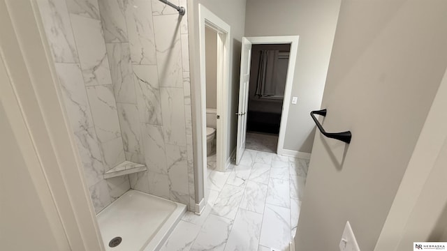 12667 161st Ave, Bennington, NE 68007 - bathroom with marble look tiles, toilet, a stall shower, and baseboards