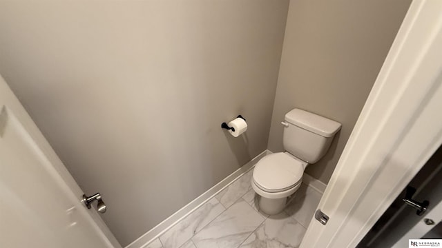 12667 161st Ave, Bennington, NE 68007 - bathroom featuring marble look tiles, toilet, and baseboards