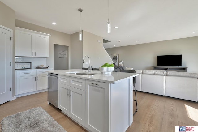 350 N 105th St, Lincoln, NE 68527 - kitchen with a sink, dishwasher, open floor plan, light wood finished floors, and white cabinets