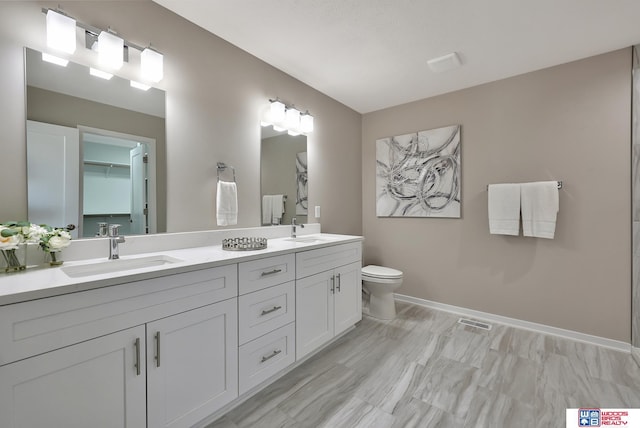 350 N 105th St, Lincoln, NE 68527 - full bath with double vanity, toilet, and baseboards