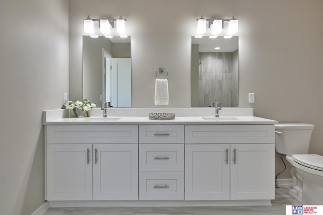 350 N 105th St, Lincoln, NE 68527 - bathroom with toilet, double vanity, a tile shower, and baseboards