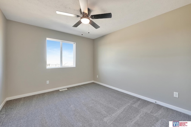 350 N 105th St, Lincoln, NE 68527 - empty room featuring a ceiling fan, dark carpet, baseboards, and a textured ceiling
