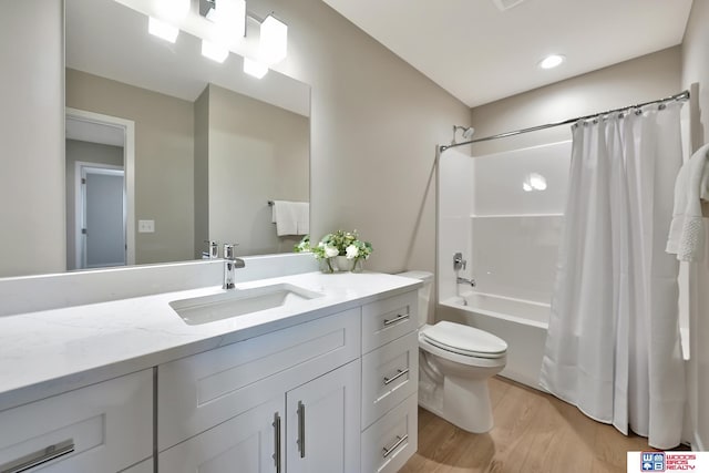 350 N 105th St, Lincoln, NE 68527 - full bathroom featuring toilet, shower / bath combo, vanity, wood finished floors, and recessed lighting