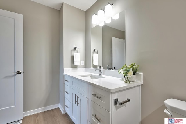 350 N 105th St, Lincoln, NE 68527 - bathroom with toilet, vanity, and wood finished floors