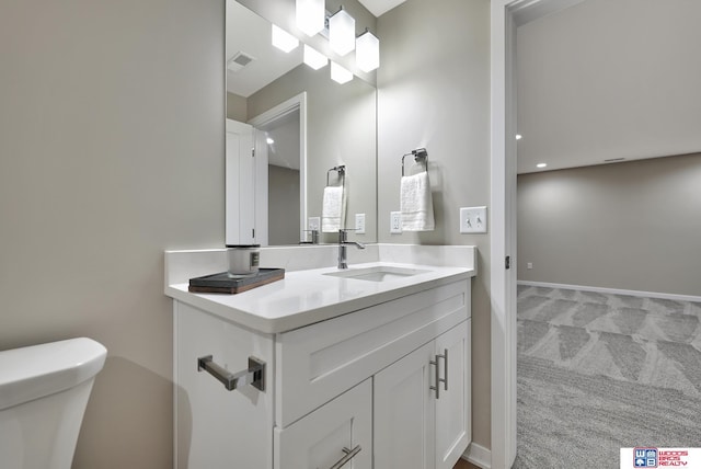 350 N 105th St, Lincoln, NE 68527 - bathroom with toilet, vanity, baseboards, and recessed lighting