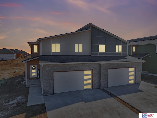 350 N 105th St, Lincoln, NE 68527 - contemporary house featuring concrete driveway, an attached garage, and roof with shingles