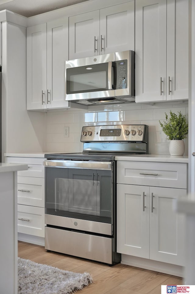 350 N 105th St, Lincoln, NE 68527 - kitchen with appliances with stainless steel finishes, decorative backsplash, and white cabinets