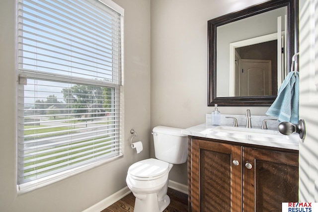 10202 N 152nd Ave, Bennington, NE 68007 - half bath with vanity, healthy amount of natural light, toilet, and baseboards