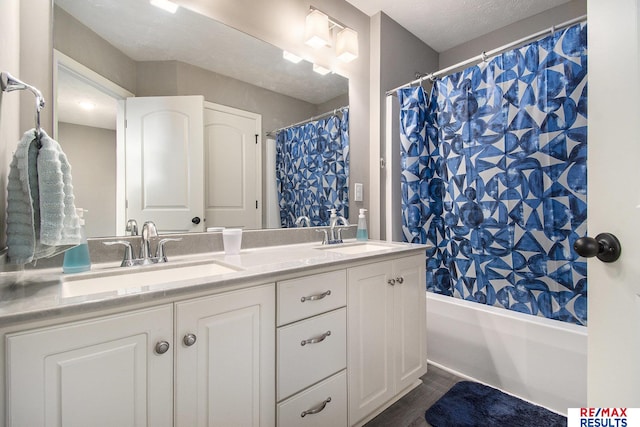 10202 N 152nd Ave, Bennington, NE 68007 - full bath featuring double vanity, shower / tub combo, and wood finished floors