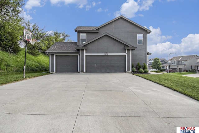 10202 N 152nd Ave, Bennington, NE 68007 - view of front of home featuring a front yard, concrete driveway, and a garage