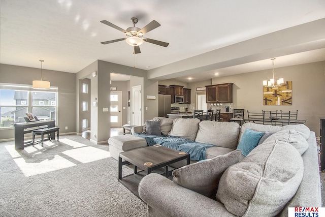 10202 N 152nd Ave, Bennington, NE 68007 - living room featuring ceiling fan, a chandelier, light carpet, and baseboards