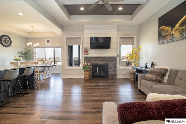 7316 Gerald Ave, Lincoln, NE 68516 - living room featuring a tray ceiling, dark wood finished floors, ceiling fan, and baseboards