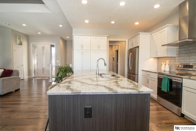7316 Gerald Ave, Lincoln, NE 68516 - kitchen featuring stainless steel appliances, wall chimney range hood, a sink, recessed lighting, and white cabinets
