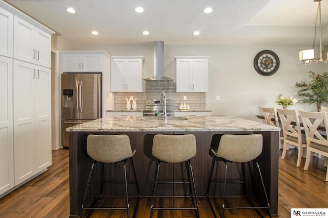 7316 Gerald Ave, Lincoln, NE 68516 - kitchen with appliances with stainless steel finishes, wall chimney range hood, a sink, tasteful backsplash, and white cabinetry