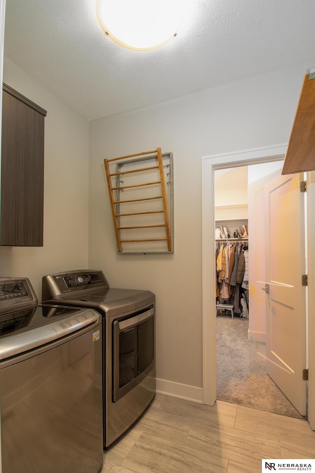 7316 Gerald Ave, Lincoln, NE 68516 - laundry area with washer and dryer, baseboards, and light wood finished floors