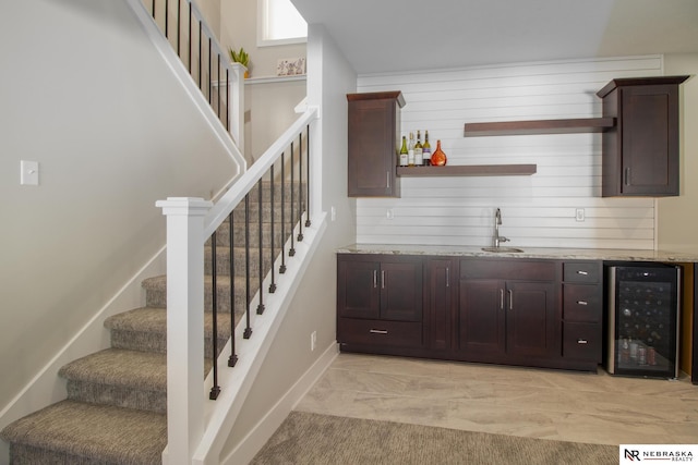 7316 Gerald Ave, Lincoln, NE 68516 - indoor wet bar with beverage cooler, stairs, baseboards, and wooden walls