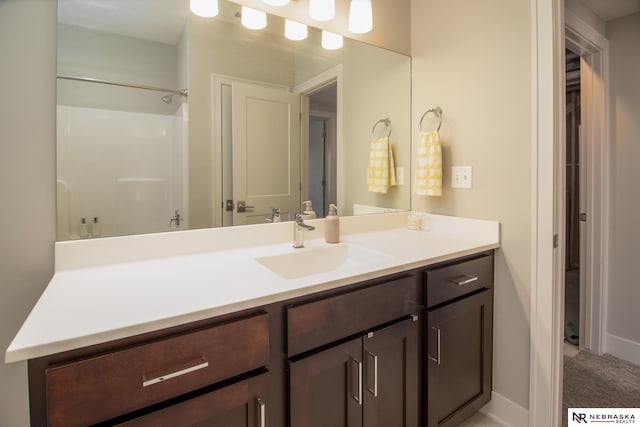 7316 Gerald Ave, Lincoln, NE 68516 - bathroom with vanity, a shower, and baseboards