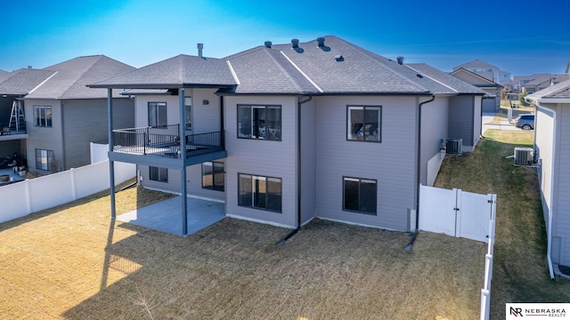 7316 Gerald Ave, Lincoln, NE 68516 - rear view of property featuring a patio area, cooling unit, a shingled roof, and a gate