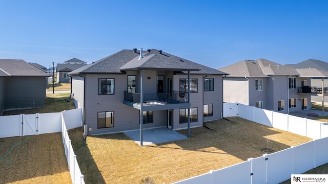7316 Gerald Ave, Lincoln, NE 68516 - back of house with a balcony, a patio, a gate, a residential view, and roof with shingles