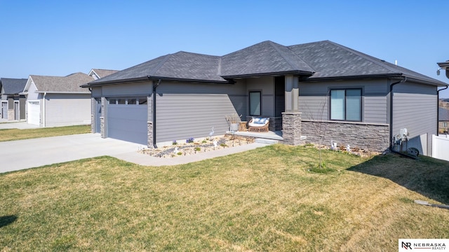 7316 Gerald Ave, Lincoln, NE 68516 - view of front of home featuring a garage, concrete driveway, a front yard, and stone siding