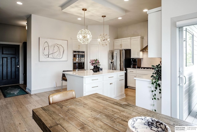 1611 S 208th St, Omaha, NE 68022 - kitchen featuring stainless steel appliances, light wood-style floors, tasteful backsplash, white cabinets, and recessed lighting