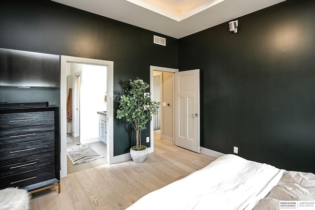 1611 S 208th St, Omaha, NE 68022 - bedroom featuring light wood-style floors, a towering ceiling, baseboards, and a tray ceiling