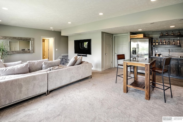 1611 S 208th St, Omaha, NE 68022 - living area featuring light colored carpet, wet bar, recessed lighting, and baseboards