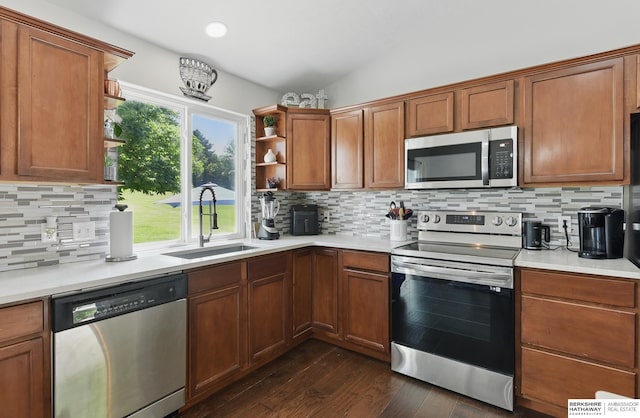 5135 N 159th Cir, Omaha, NE 68116 - kitchen featuring stainless steel appliances, a sink, open shelves, dark wood finished floors, and light countertops